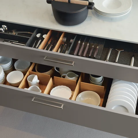 Moderne Designküche mit offenen Schubladen für Besteck und Geschirr – hochwertige Küchenorganisation für exklusive Premiumküchen